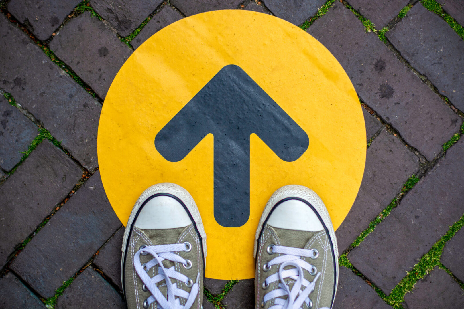 A person standing on the ground with their feet up.